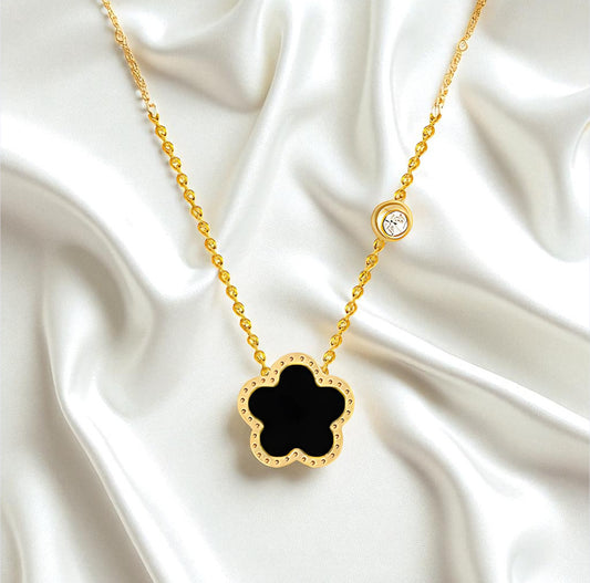 Gold necklace with a black clover pendant on a white satin background Waterproof Jewllery Piece SweatProof